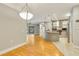 Open concept living space with kitchen island, pendant lighting, hardwood floors, and view to a covered patio at 5168 Northridge Rd # 106, Sarasota, FL 34238