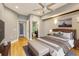 Spacious main bedroom with hardwood floors, ceiling fan, and en-suite bathroom access at 5168 Northridge Rd # 106, Sarasota, FL 34238