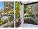 Screened in patio features white tile flooring and natural views at 5168 Northridge Rd # 106, Sarasota, FL 34238
