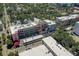 Urban aerial view highlights a mix of colorful buildings, rooftops, and lush greenery at 525 N Orange Ave # 202, Sarasota, FL 34236