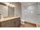 Bathroom featuring a large glass-door shower, gray vanity, and decorative mirror at 525 N Orange Ave # 202, Sarasota, FL 34236