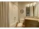 Cozy bathroom with a shower-tub combo, light vanity, and a decorative mirror at 525 N Orange Ave # 202, Sarasota, FL 34236