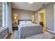 Neutral bedroom with a plush bed, side tables with lamps, and view of the bathroom at 525 N Orange Ave # 202, Sarasota, FL 34236