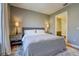 Neutral bedroom with a plush bed, side tables with lamps, and view of the bathroom at 525 N Orange Ave # 202, Sarasota, FL 34236