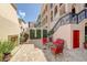 Relaxing courtyard featuring brick pavers, wrought iron railings, comfortable seating, and green landscaping at 525 N Orange Ave # 202, Sarasota, FL 34236
