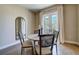 Charming dining area featuring a round table, four chairs, and French doors leading to a balcony at 525 N Orange Ave # 202, Sarasota, FL 34236