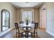 Bright dining area with a round table, seating for four, with a mirror and access to the entryway at 525 N Orange Ave # 202, Sarasota, FL 34236