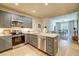 Open kitchen with stainless steel appliances and view of the dining and living area at 525 N Orange Ave # 202, Sarasota, FL 34236