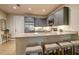 Modern kitchen with stainless steel appliances, granite countertops, and gray cabinets at 525 N Orange Ave # 202, Sarasota, FL 34236