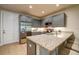 Modern kitchen with stainless steel appliances, granite countertops, and gray cabinets at 525 N Orange Ave # 202, Sarasota, FL 34236