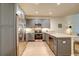 Well-lit kitchen with stainless steel appliances, granite countertops, and gray cabinets at 525 N Orange Ave # 202, Sarasota, FL 34236
