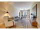 Comfortable living room with a sofa, accent chair, stylish rug, and dining area, offering a relaxing space at 525 N Orange Ave # 202, Sarasota, FL 34236