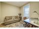 Bright living room showcasing a comfy sofa, patterned rug, and an antique-style desk with a lamp at 525 N Orange Ave # 202, Sarasota, FL 34236