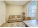 Cozy living room featuring a comfortable couch, bright window, and stylish area rug at 525 N Orange Ave # 202, Sarasota, FL 34236