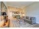 Cozy living room with open floor plan, showcasing a sofa, area rug, and a glimpse into the kitchen at 525 N Orange Ave # 202, Sarasota, FL 34236