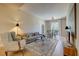 Bright living room featuring a plush sofa, armchair, area rug, and adjacent dining area with lots of natural light at 525 N Orange Ave # 202, Sarasota, FL 34236