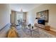 Comfortable living room with a plush sofa, decorative rug, TV, and a view of the dining area at 525 N Orange Ave # 202, Sarasota, FL 34236
