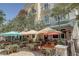 Inviting outdoor seating area with tables, chairs, and umbrellas, perfect for dining al fresco at 525 N Orange Ave # 202, Sarasota, FL 34236