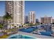 Beautiful aerial view of waterfront condos with a pool and boat marina, with blue skies in the background at 555 Quay Cmn # 1003, Sarasota, FL 34236