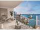 Spacious condo balcony with seating area and outdoor grill, boasting panoramic waterfront views at 555 Quay Cmn # 1003, Sarasota, FL 34236