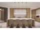 Modern kitchen with a large island, pendant lighting, stainless steel appliances, and lots of cabinet space at 555 Quay Cmn # 1003, Sarasota, FL 34236