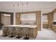 Modern kitchen with a large island, pendant lighting, stainless steel appliances, and lots of cabinet space at 555 Quay Cmn # 1003, Sarasota, FL 34236