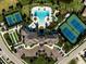 Stunning aerial view of community amenities including pool, clubhouse, tennis, and lawn bowling courts at 5770 Long Shore Loop, Sarasota, FL 34238