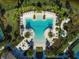 Overhead view of a modern pool with lounge chairs, lush landscaping, and manicured grounds at 5770 Long Shore Loop, Sarasota, FL 34238
