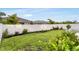 Green backyard featuring a white fence, manicured lawn, and tasteful landscaping at 5770 Long Shore Loop, Sarasota, FL 34238