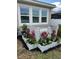 Cozy backyard planter area featuring flowers, white lattice and rock ground covering at 5770 Long Shore Loop, Sarasota, FL 34238