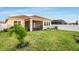 Lush backyard with a screened-in patio, privacy fence, and well-kept lawn at 5770 Long Shore Loop, Sarasota, FL 34238