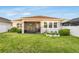 Spacious backyard featuring a screened-in patio area and manicured lawn at 5770 Long Shore Loop, Sarasota, FL 34238