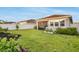 Well-maintained backyard with lush green grass, landscaping, white fence, and a screened-in patio at 5770 Long Shore Loop, Sarasota, FL 34238