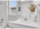 Bathroom featuring a single vanity, white cabinets, quartz countertops, and modern lighting fixtures at 5770 Long Shore Loop, Sarasota, FL 34238