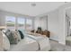 Bright bedroom with plush bedding, three large windows, and stylish decor at 5770 Long Shore Loop, Sarasota, FL 34238