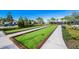 Picturesque bocce ball courts for recreational fun, surrounded by manicured landscaping and community amenities at 5770 Long Shore Loop, Sarasota, FL 34238