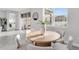 Sunny dining area featuring a round table, 4 chairs, and a view of the back yard at 5770 Long Shore Loop, Sarasota, FL 34238
