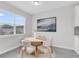 Bright dining area featuring a round table, modern chairs, neutral walls, and modern art at 5770 Long Shore Loop, Sarasota, FL 34238