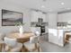 Bright dining area next to the kitchen featuring round table with modern chairs and modern art at 5770 Long Shore Loop, Sarasota, FL 34238