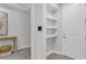 Light, airy entryway with built-in shelves and a door to the right at 5770 Long Shore Loop, Sarasota, FL 34238