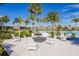 Inviting community fire pit surrounded by comfortable Adirondack chairs, perfect for relaxing and socializing near the pool at 5770 Long Shore Loop, Sarasota, FL 34238