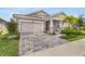 Charming single-Gathering home boasting a landscaped yard, a two-car garage, and a welcoming front porch at 5770 Long Shore Loop, Sarasota, FL 34238