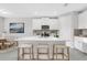 Modern kitchen with a large island, stainless steel appliances, and bar seating at 5770 Long Shore Loop, Sarasota, FL 34238
