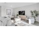 Comfortable living room with ample seating, a large television, and stylish decor at 5770 Long Shore Loop, Sarasota, FL 34238