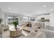 Bright, open-concept living room with large windows, tile floors, and access to the backyard at 5770 Long Shore Loop, Sarasota, FL 34238