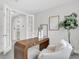 Home office with modern desk, chair, stylish decor, and glass french doors at 5770 Long Shore Loop, Sarasota, FL 34238