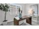 Bright Home office with modern desk, chair, stylish decor, and large windows at 5770 Long Shore Loop, Sarasota, FL 34238