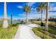 Charming outdoor picnic area by a lake with lush landscaping and convenient grill for outdoor meals and gatherings at 5770 Long Shore Loop, Sarasota, FL 34238