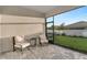 Relaxing screened patio featuring comfortable seating and views of the lush, private backyard at 5770 Long Shore Loop, Sarasota, FL 34238
