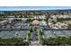 Aerial view of the community featuring well-maintained tennis courts, swimming pool, and lush landscaping at 603 Cedars Ct, Longboat Key, FL 34228